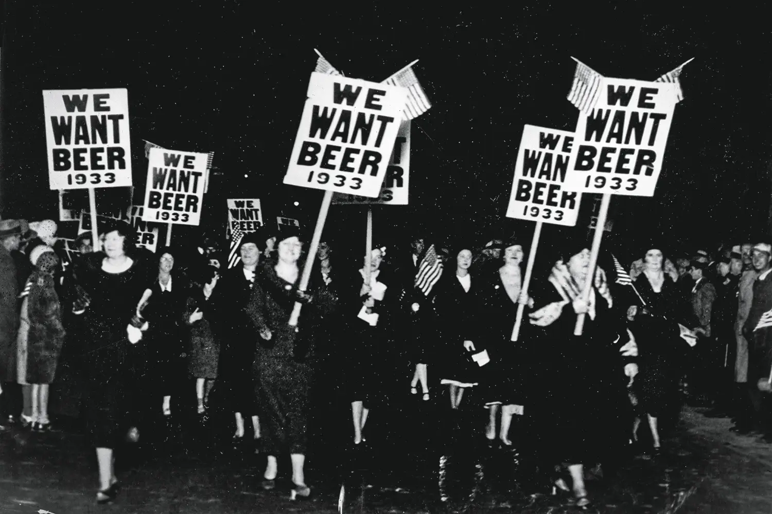Old black and white photograph of women protesting holding signs that read: We Want Beer